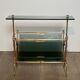 Brass magazine rack and blue-tinted glasses