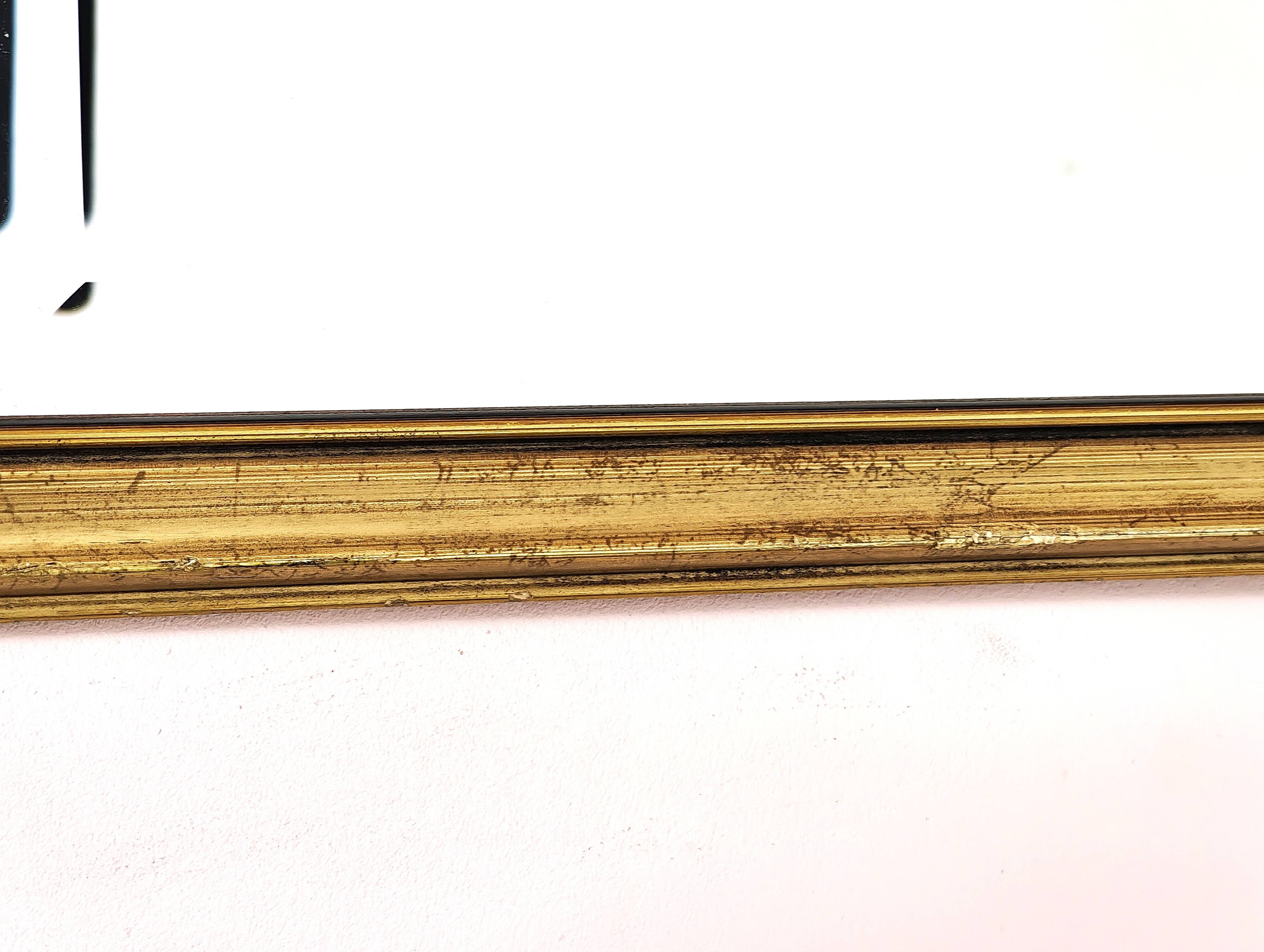 Rectangular gold mirror with bevelled glass.