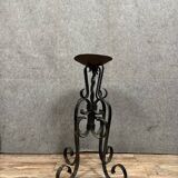 Wrought iron candlestick on four-legged base circa 1900-1930