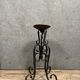 Wrought iron candlestick on four-legged base circa 1900-1930