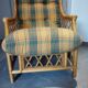 Vintage armchair in bamboo and rattan with a tartan pattern.