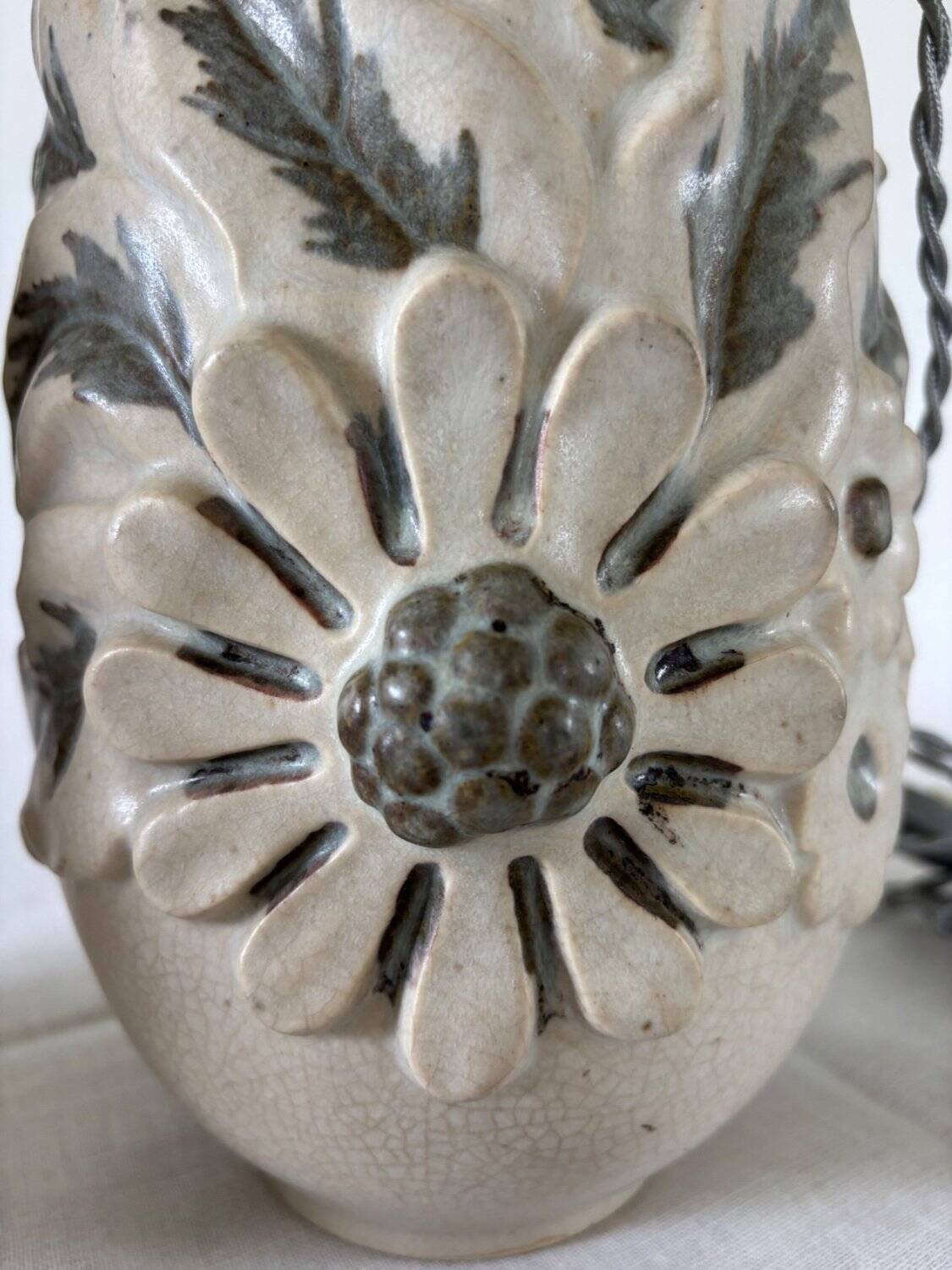 Pair of white glazed stoneware lamp bases, 20th-century floral decoration.