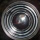Large silver metal tray raised by a central foot
