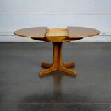 Round teak table with an extension.