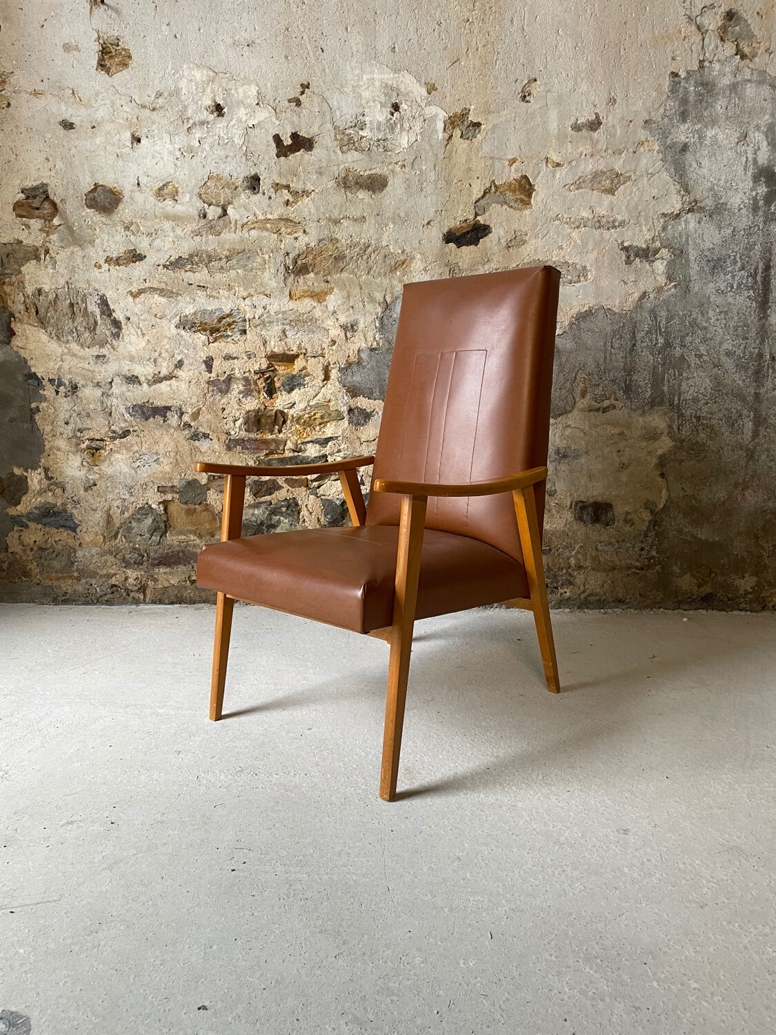 Vintage armchair in wood and brown faux leather