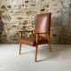 Vintage armchair in wood and brown faux leather