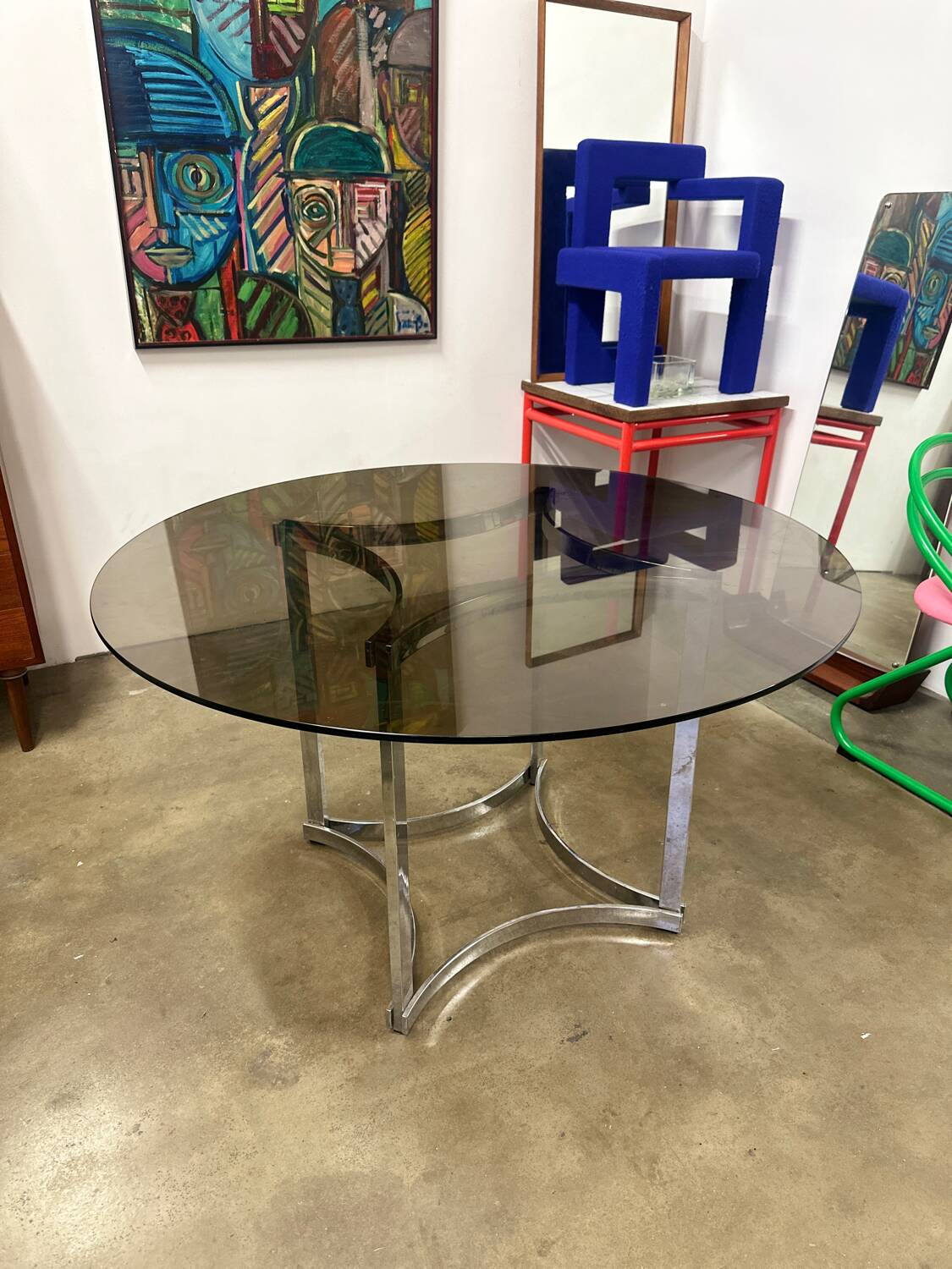 Dining table in chrome metal and smoked glass.