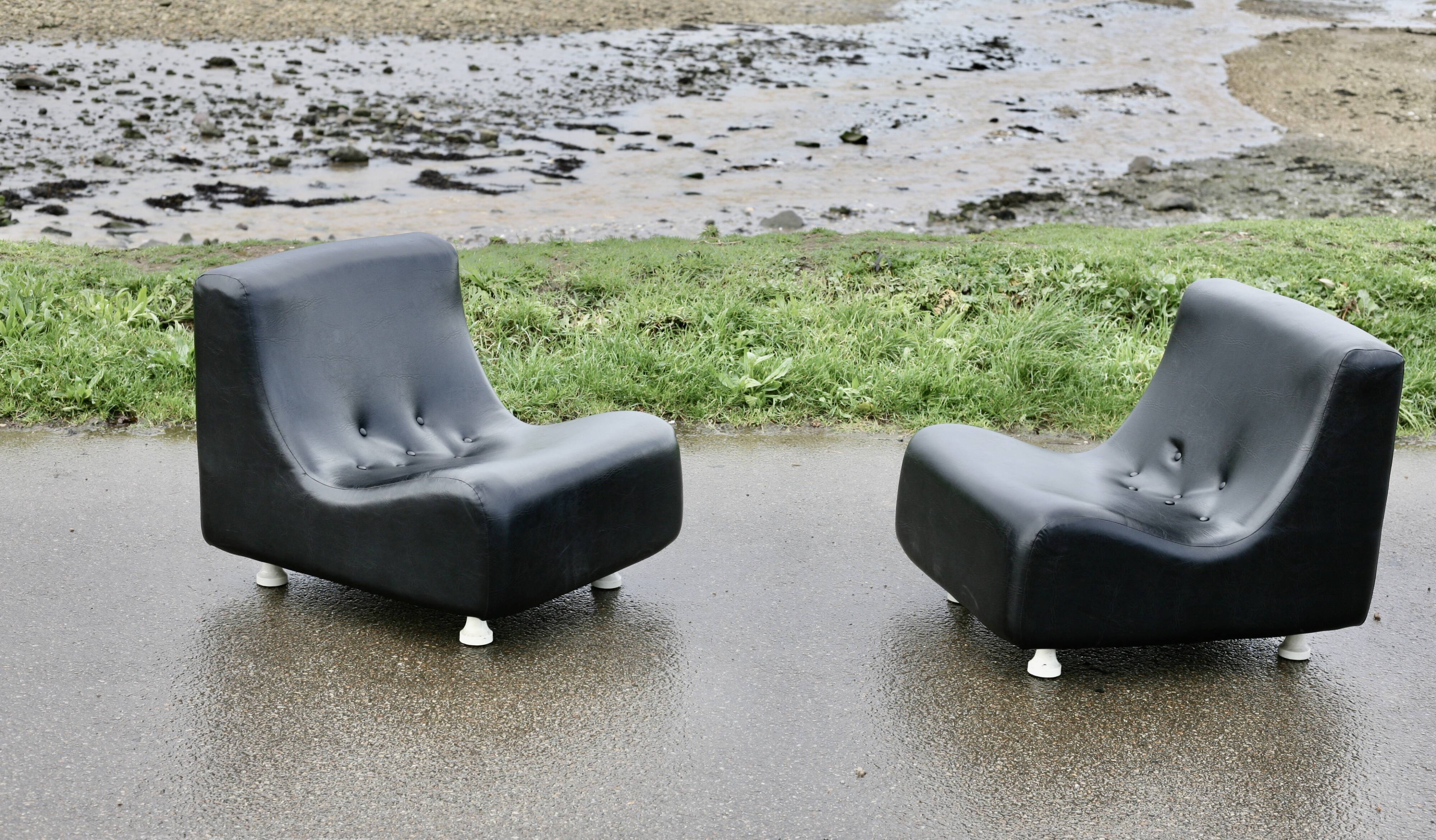 Pair of “space age” low chairs. Black faux leather. Circa 1970