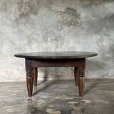 Coffee table, round antique Indonesian teak table with straight legs.