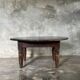 Coffee table, round antique Indonesian teak table with straight legs.