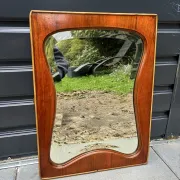 Mid-century organic shaped bevelled mirror in wooden frame, 1940s-50s