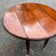 Antique round mahogany table, turned and fluted legs