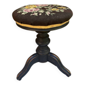 Old adjustable piano stool, blackened wood, metal screws, embroidered seat.
