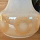 2 vintage pendant lights in white opaline with orange patterns and chrome.