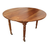 Round extending table in solid walnut, 19th century