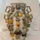 Large antique vase with relief decorations of coloured fruits.