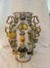 Large antique vase with relief decorations of coloured fruits.