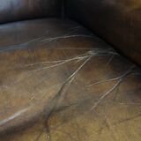 Patinated cowhide leather armchair