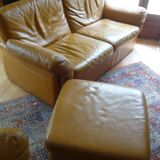 Tan leather sofa with natural graining, matching armchair and pouf