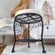 Black iron stool/pouf with its boucle fabric cushion.