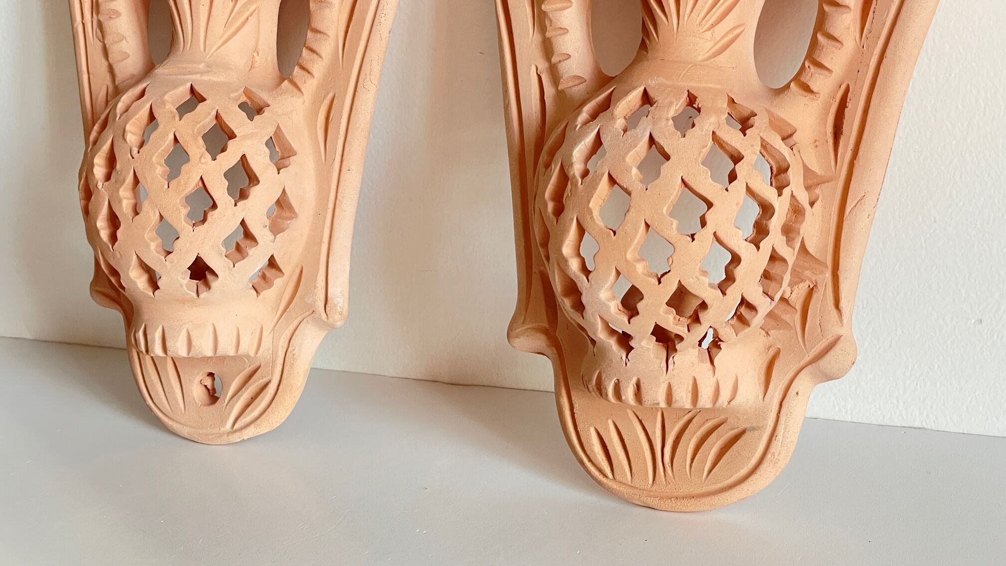 Pair of terracotta wall candle holders