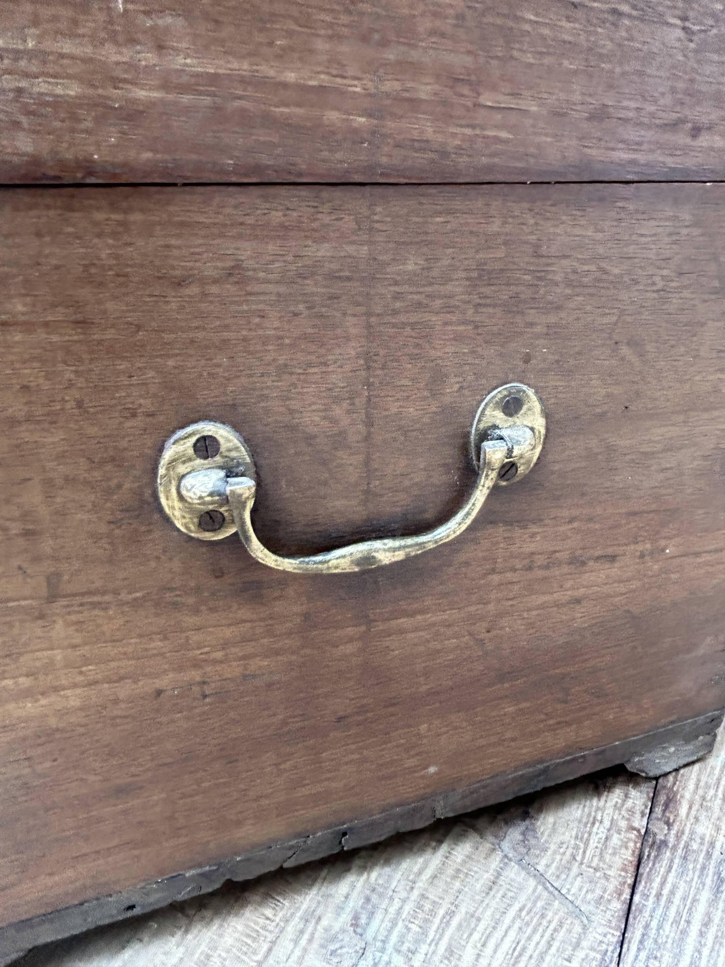 Teak chest from Burma with carved rosettes.