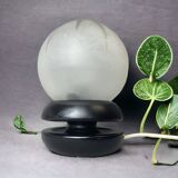 Small black wooden table lamp with frosted glass globe
