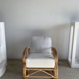 Large rattan rest chair and white cushions