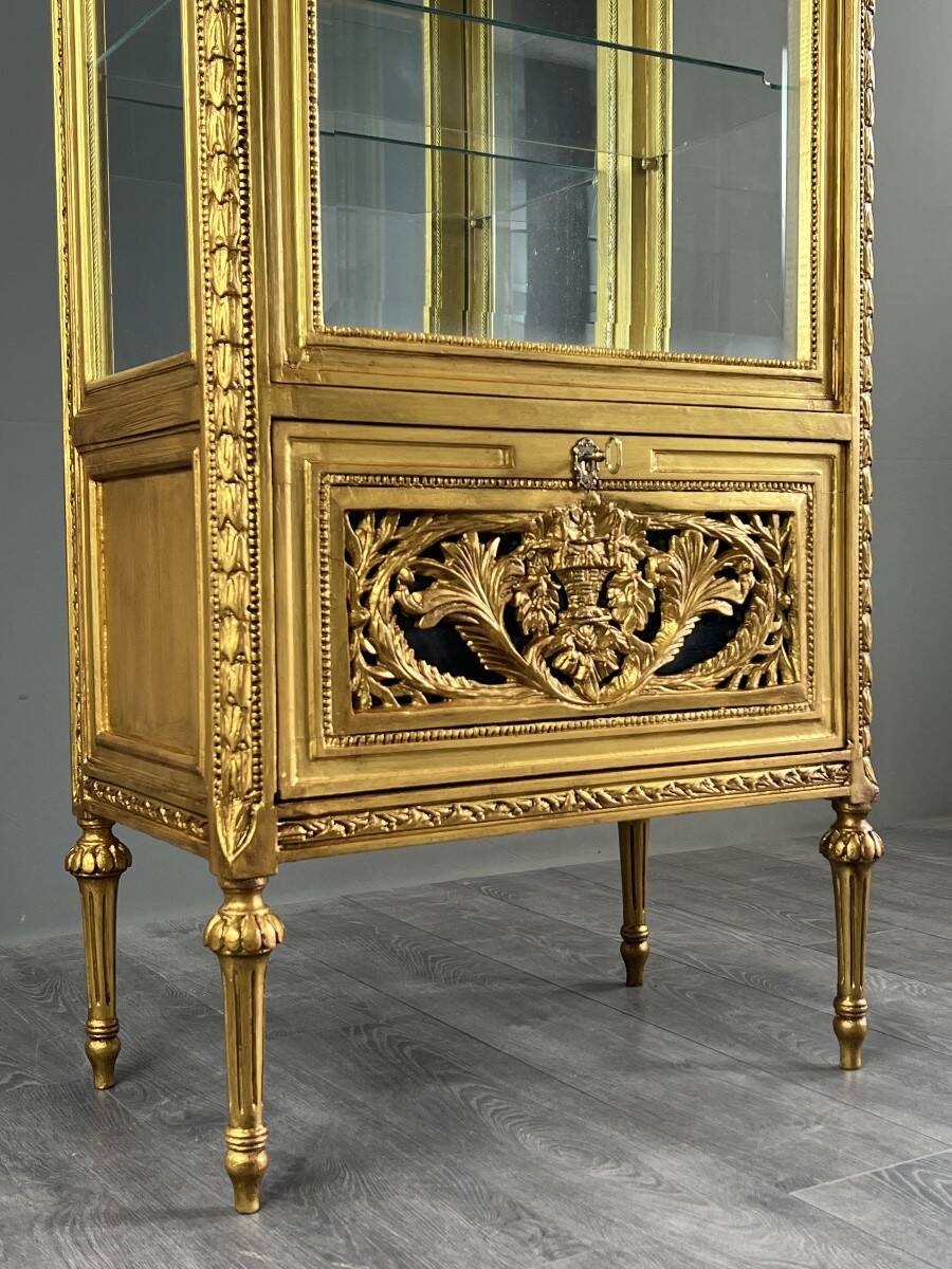 Carved and gilded wooden display cabinet, Louis XVI style, 20th century.