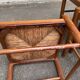 4 solid wood kitchen chairs with straw seats in a country farmhouse style.