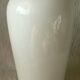 Thick white porcelain vase with relief decoration of a flying duck.
