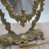 Adjustable psyche mirror of 33 centimeters in gilded bronze with angel ornament