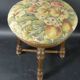 Old upholstered piano stool