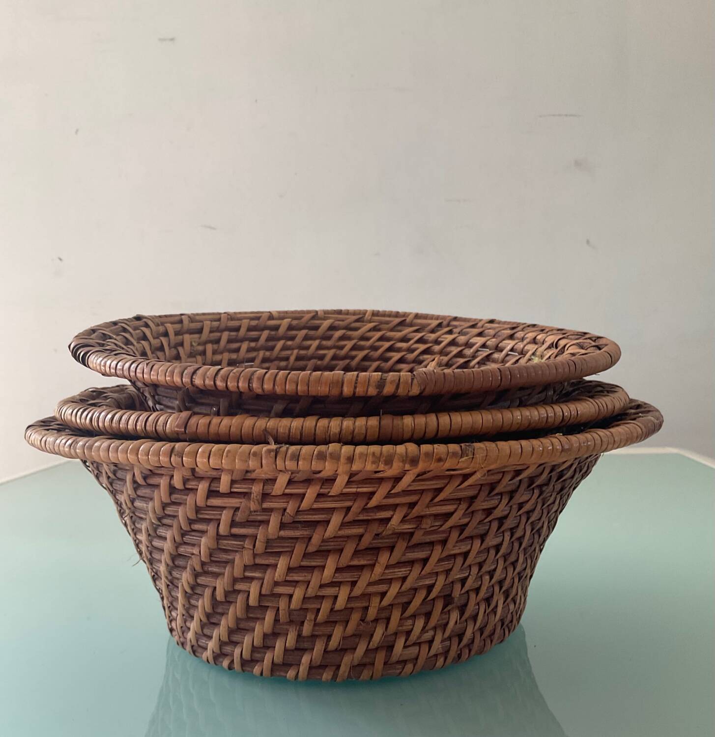 Trio of vintage woven rattan and wicker baskets