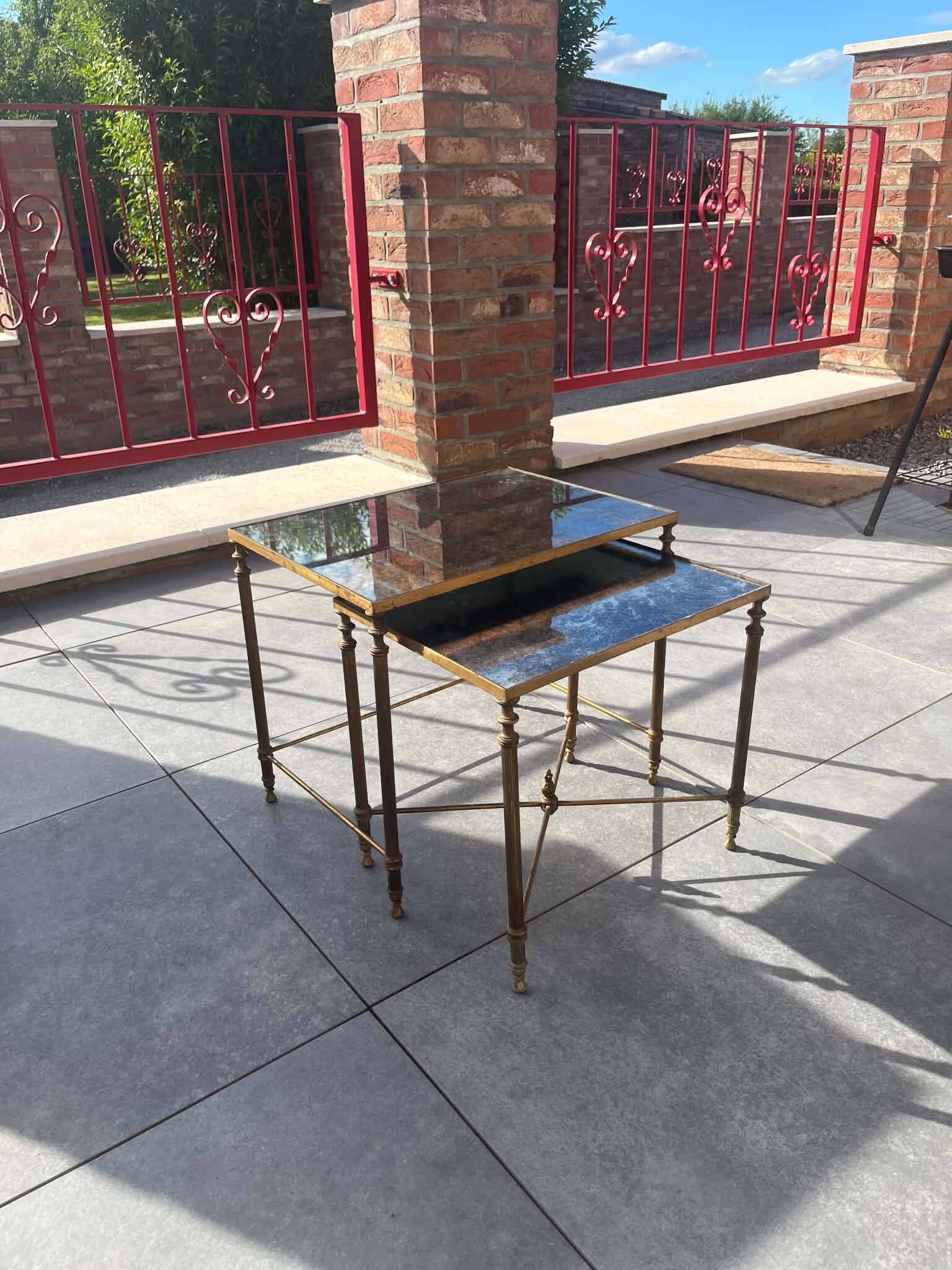 Pair of vintage nesting tables in gilded bronze and oxidised blue mirror, style