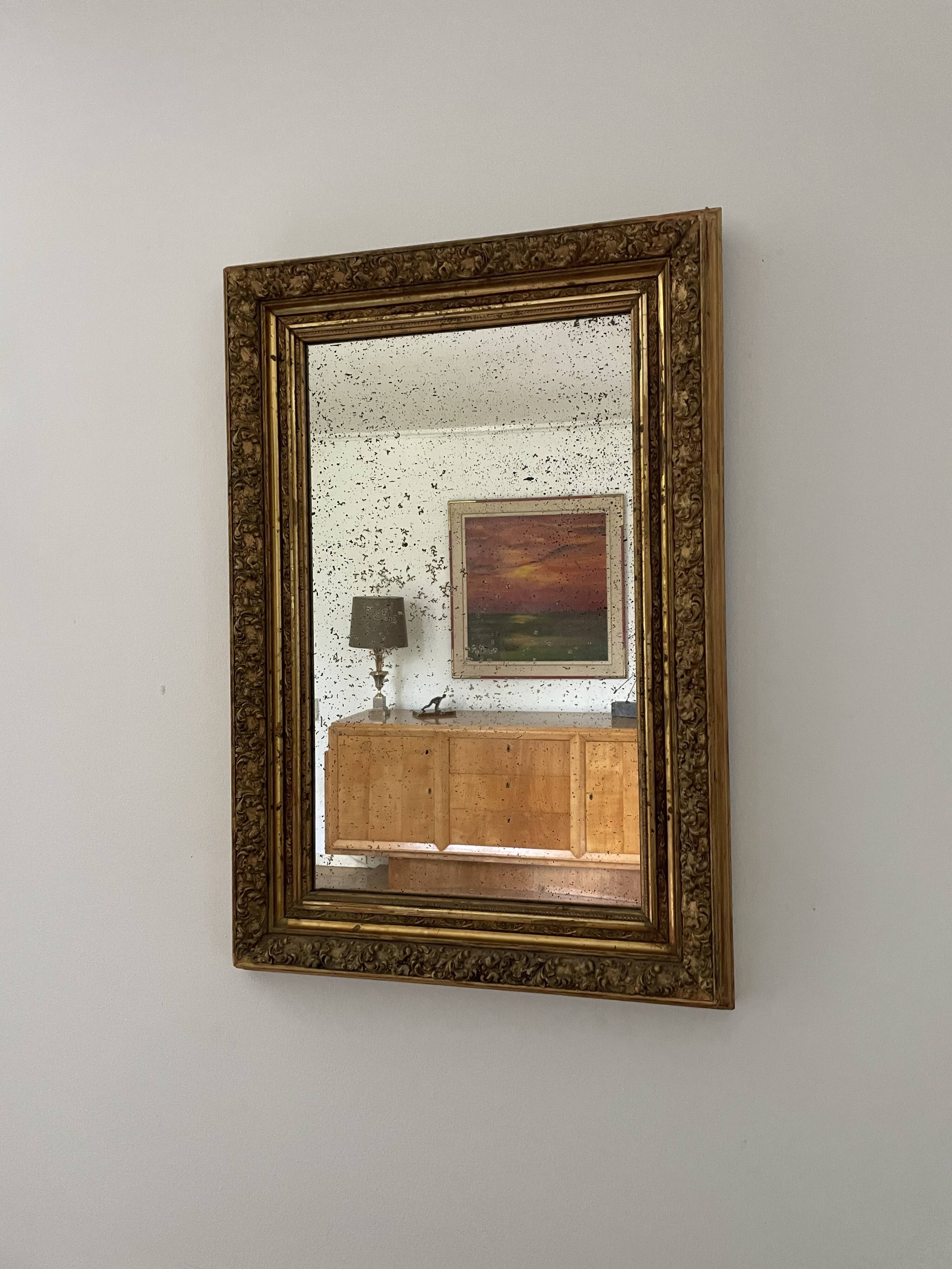 Antique mirror in gilded wood