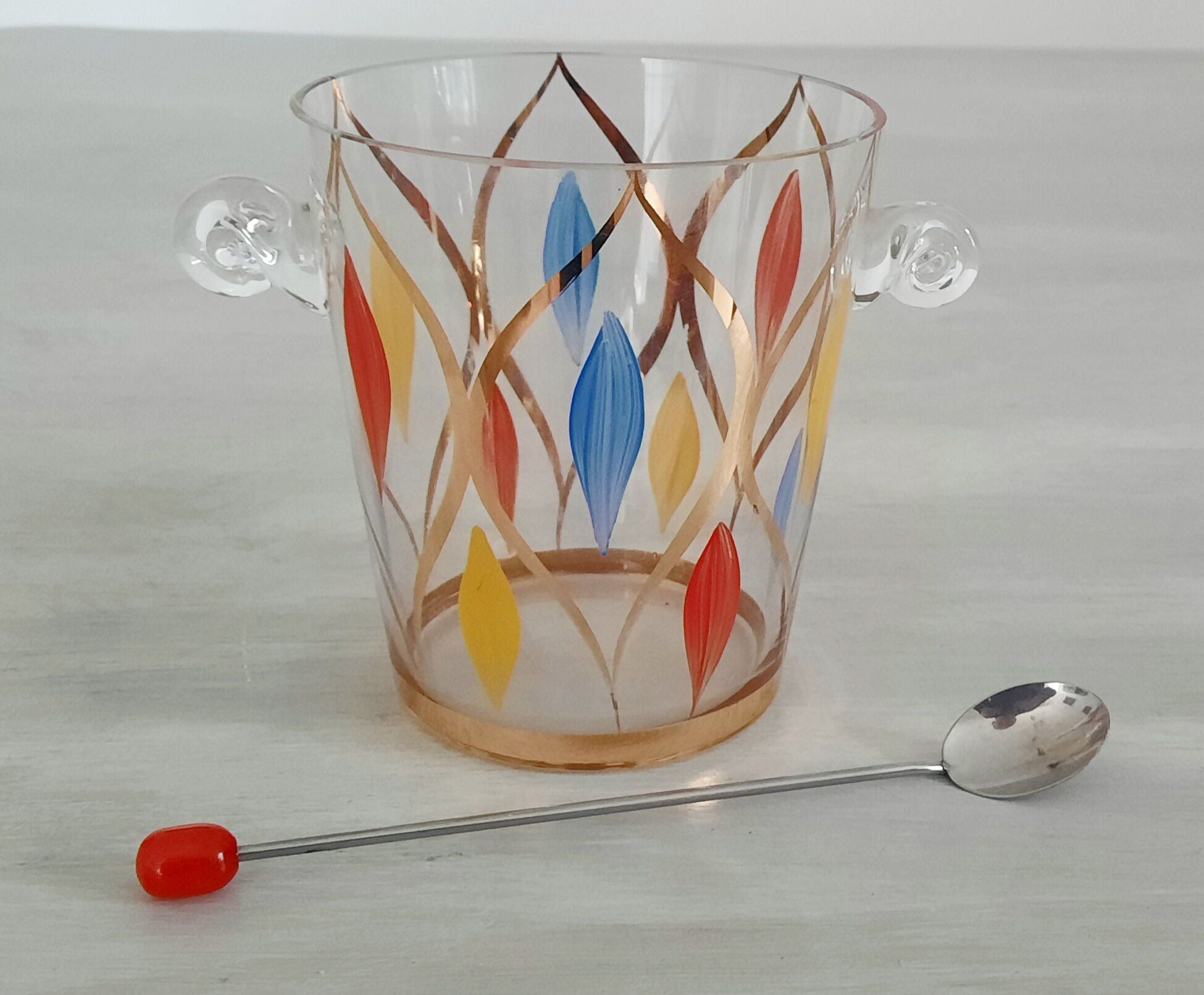 Glass ice bucket, metal spoon and vintage bakelite