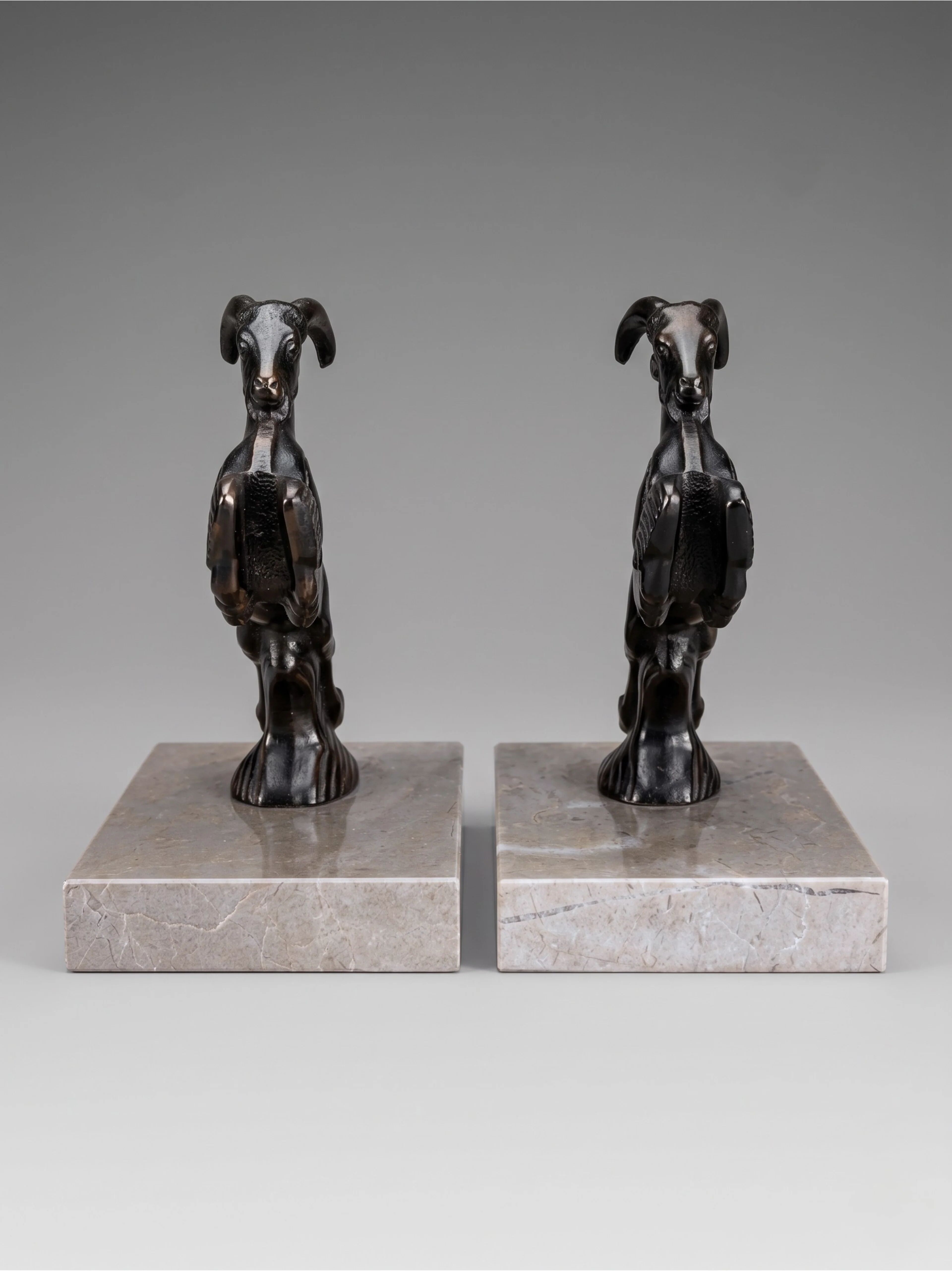 Art Deco bookends with patinated ibex in a taupe marble base.