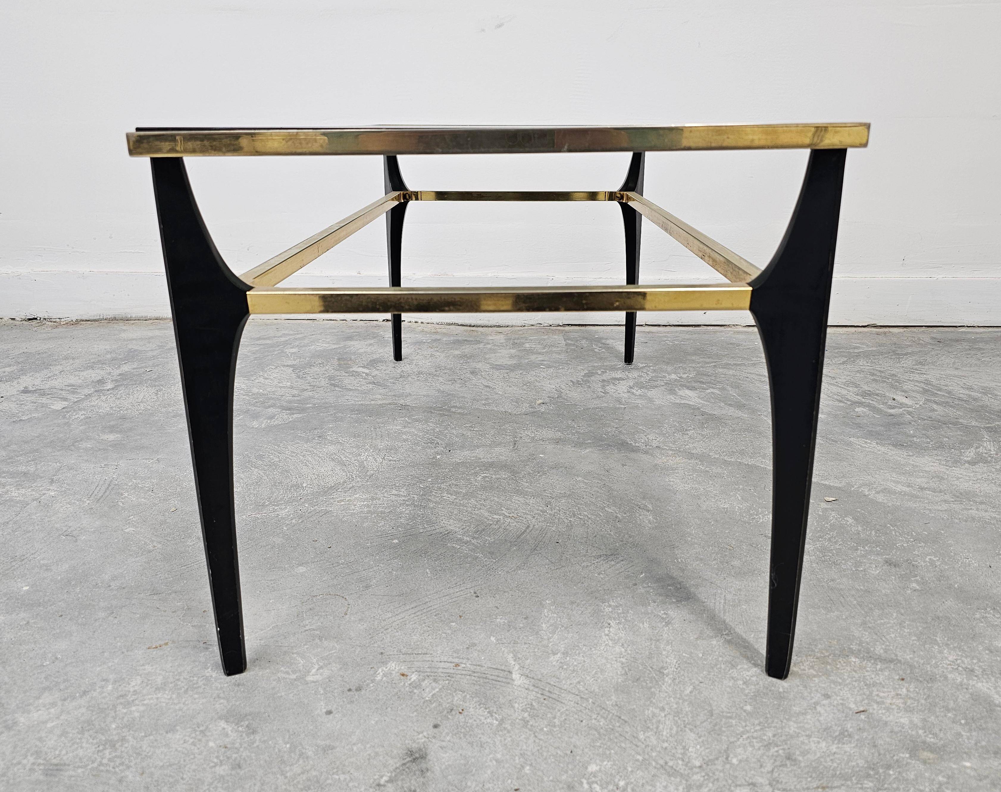 Mid Century Modern coffee table with gold-plated metal and smoked glass.