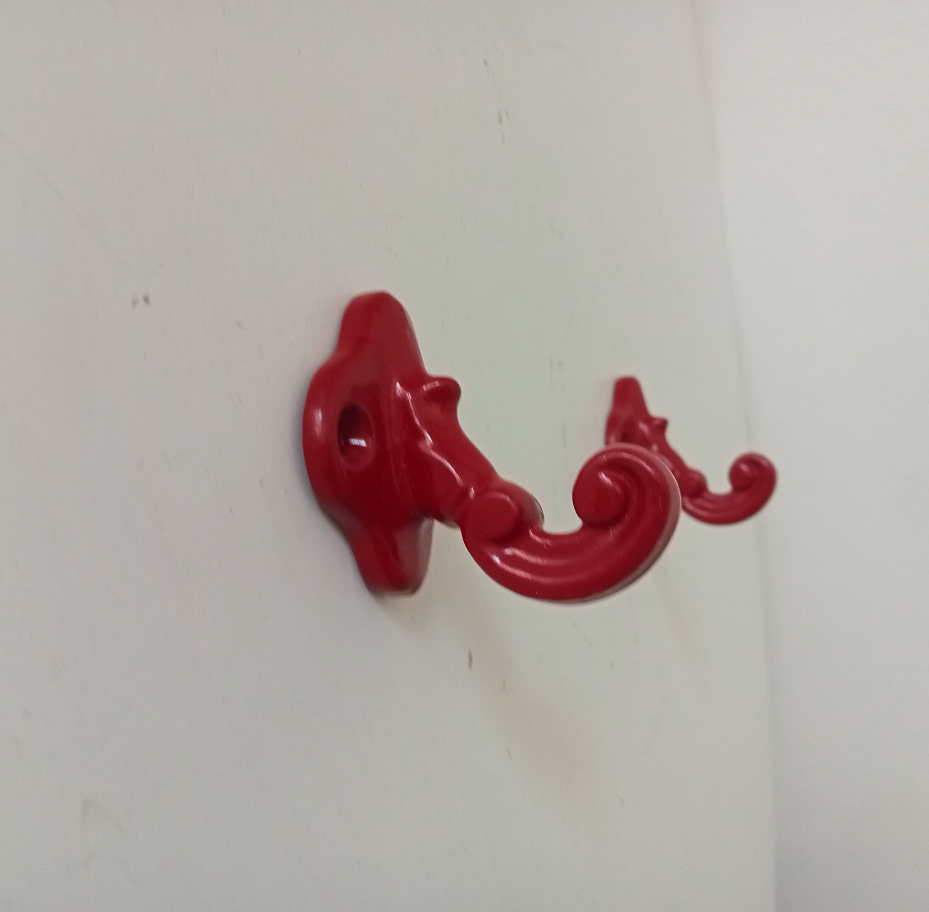 Pair of vintage wall hooks in enamelled cast iron.