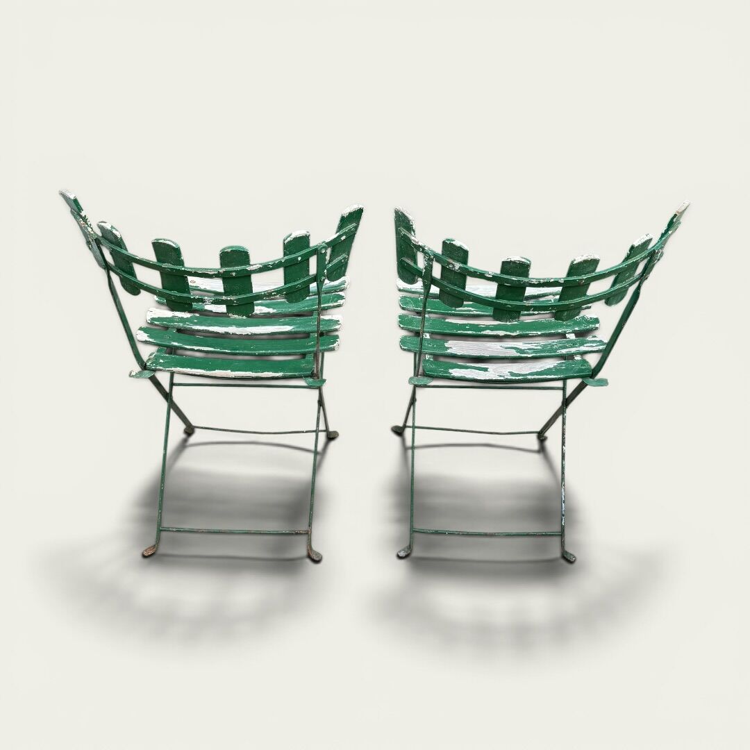 Pair of original patinated folding Parisian bistro chairs.