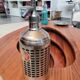 Seltzer water siphon in its protective grid
