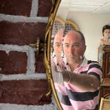 Beveled oval mirror in gilded bronze