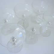 Suite of six champagne glasses on foot in engraved colorless crystal