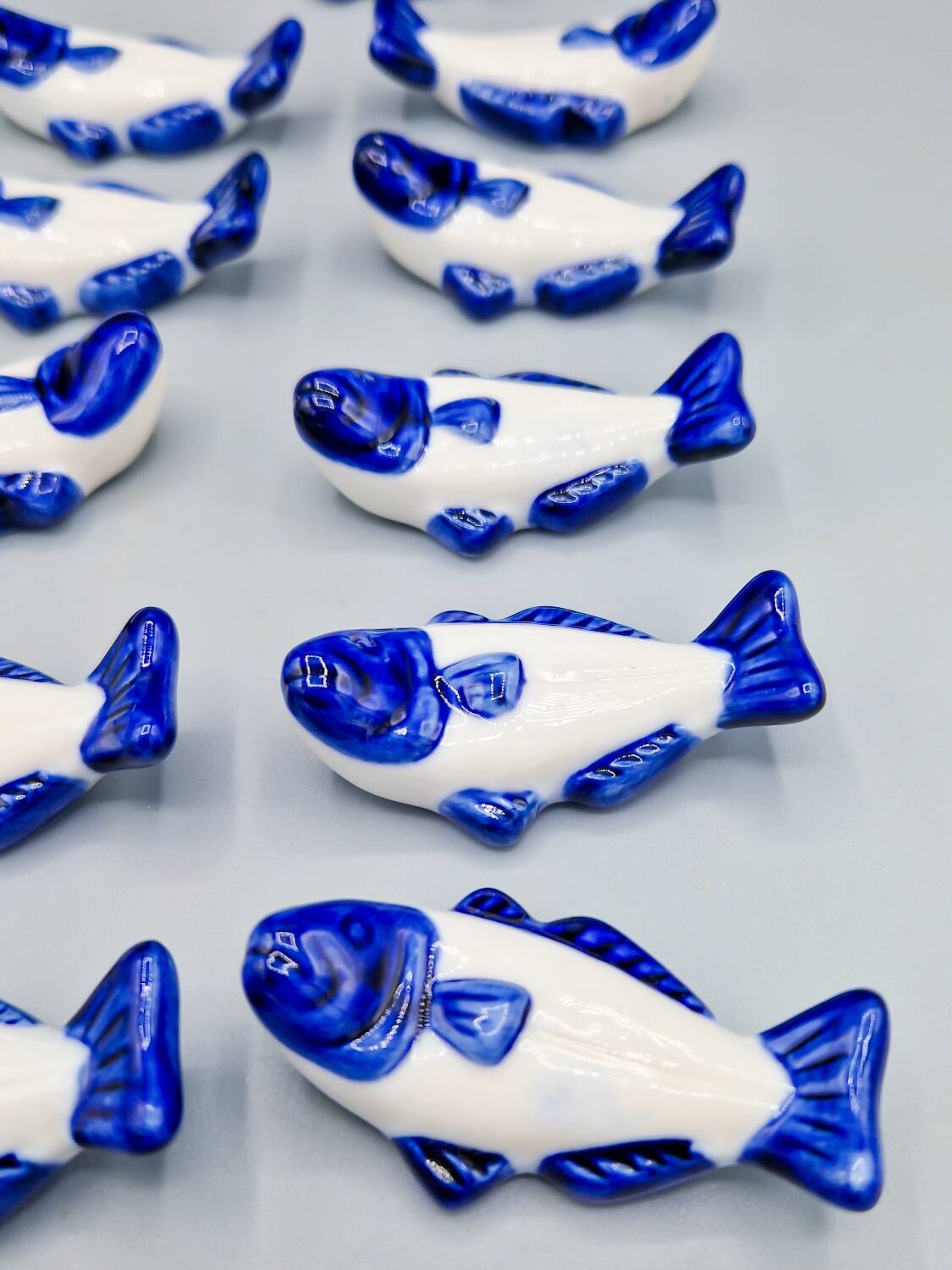 Set of 11 vintage blue and white porcelain fish knife rests.