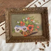 Old painting of a bouquet of pansies and poppies.