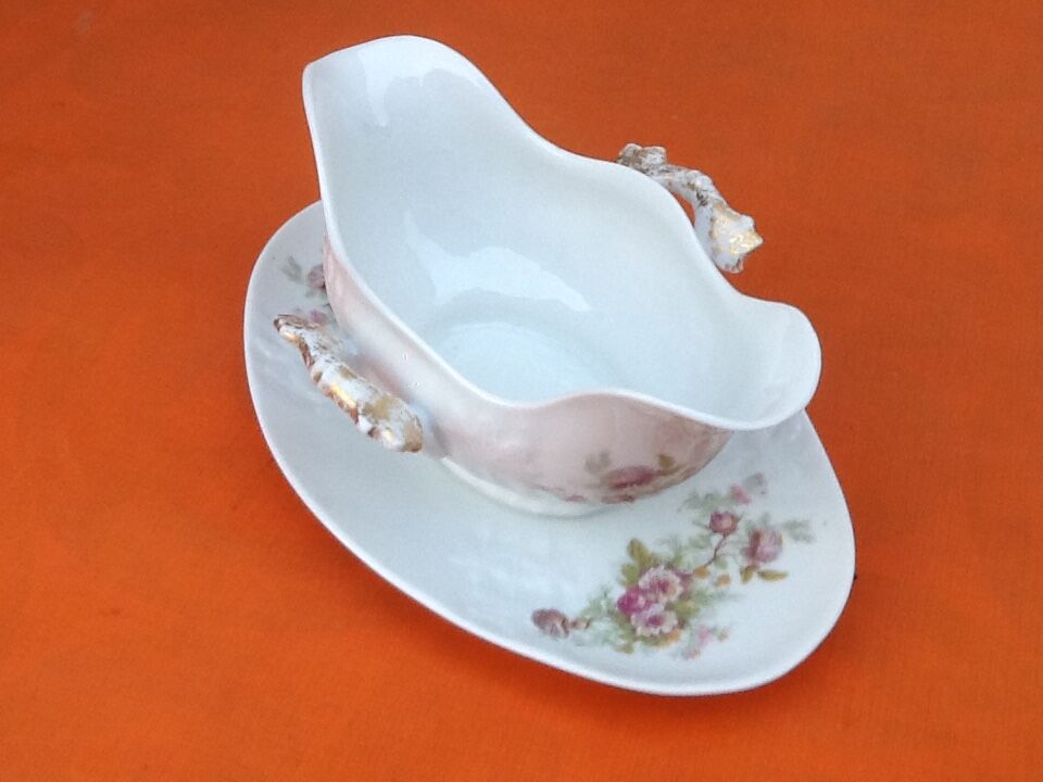 Sauce boat on dormant white porcelain, floral decoration