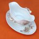 Sauce boat on dormant white porcelain, floral decoration