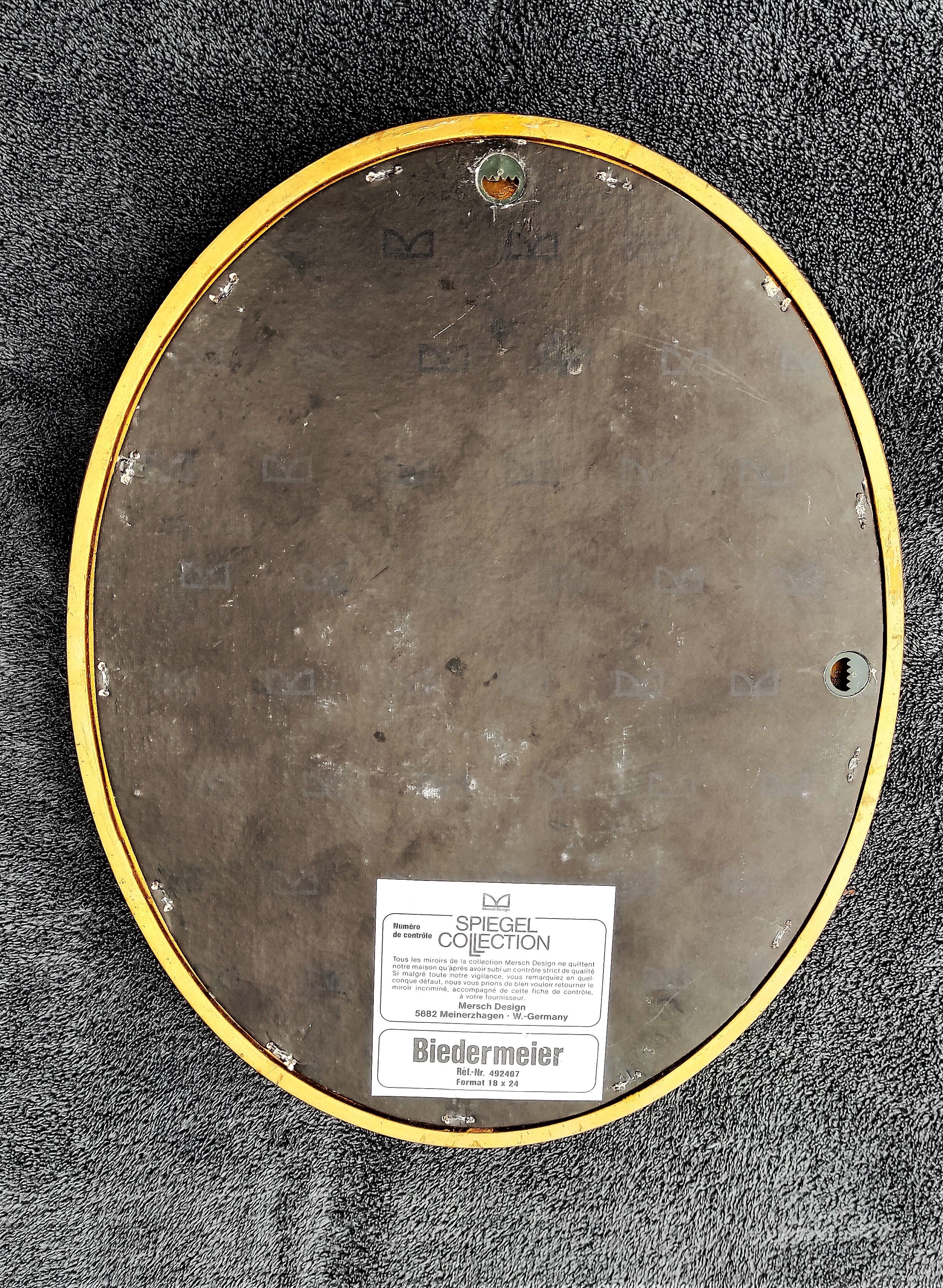 Oval mirror of 30 x 24 cm with its golden entourage of biedermeier