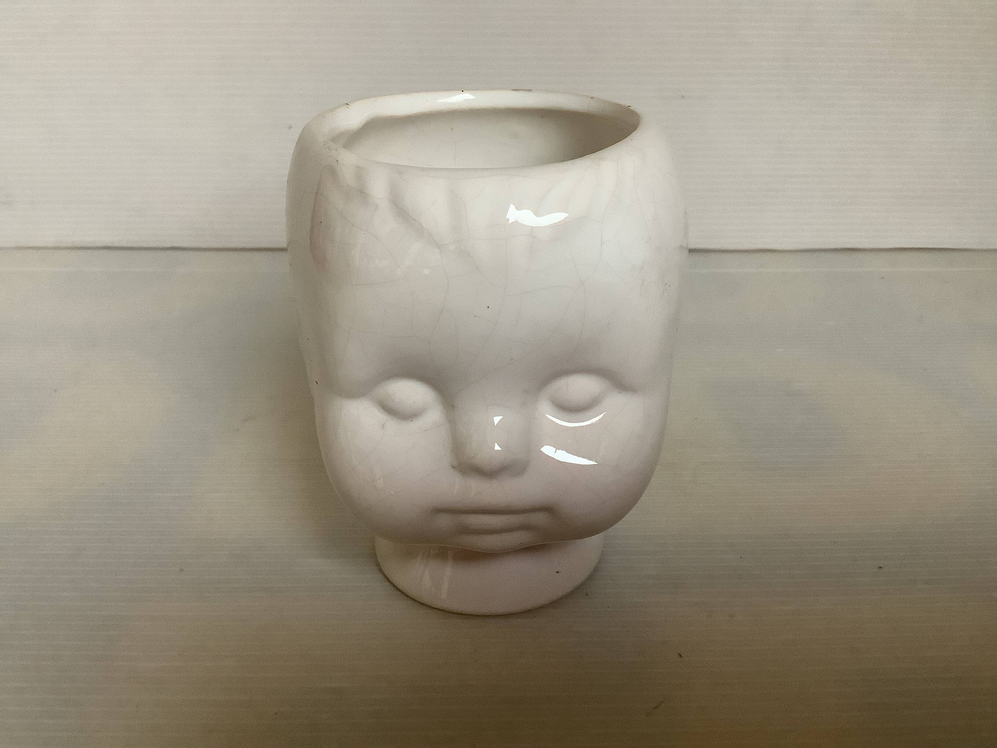 Baby doll shaped vase planter